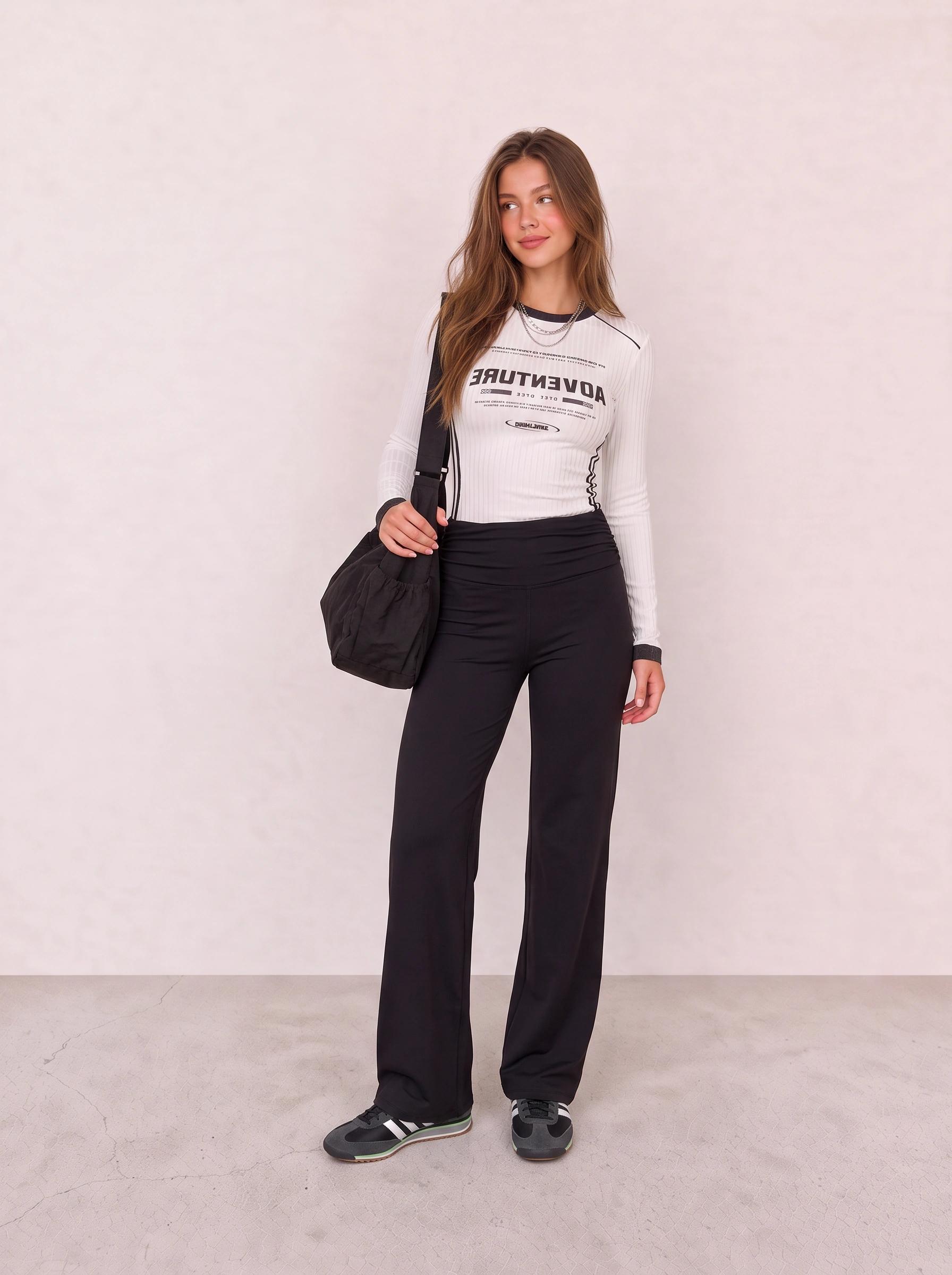 White Graphic Top and Black Flared Leggings Outfit