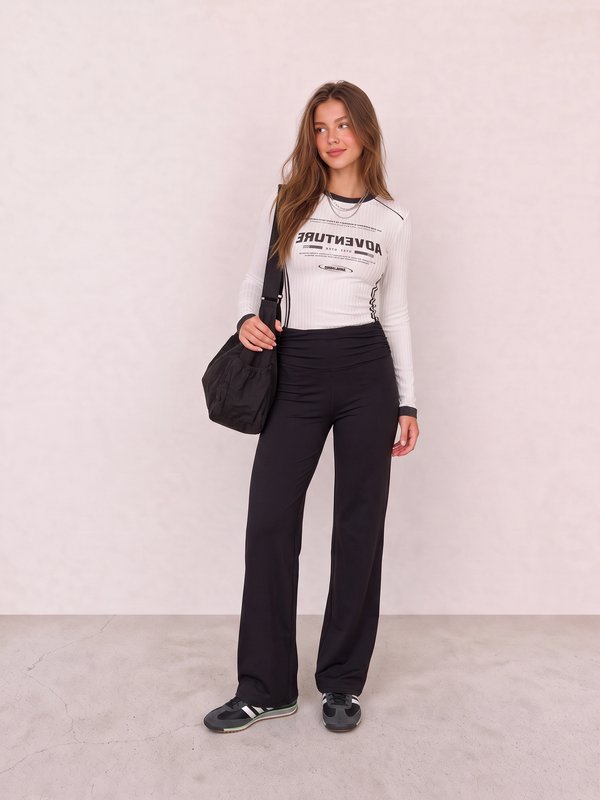White Graphic Top and Black Flared Leggings Outfit