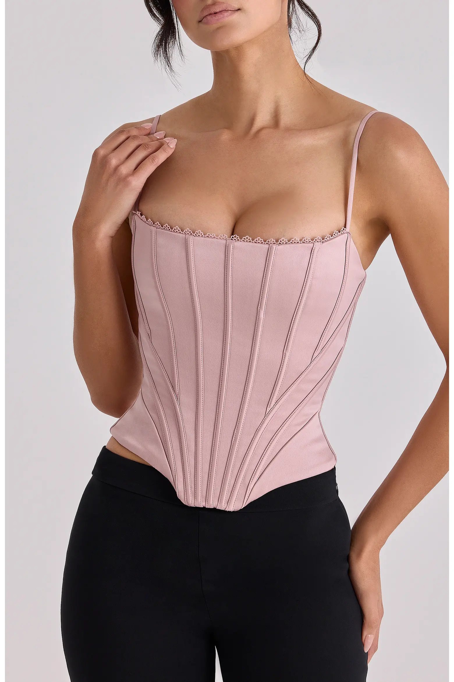 Blush pink corset top with black belted denim mini skirt