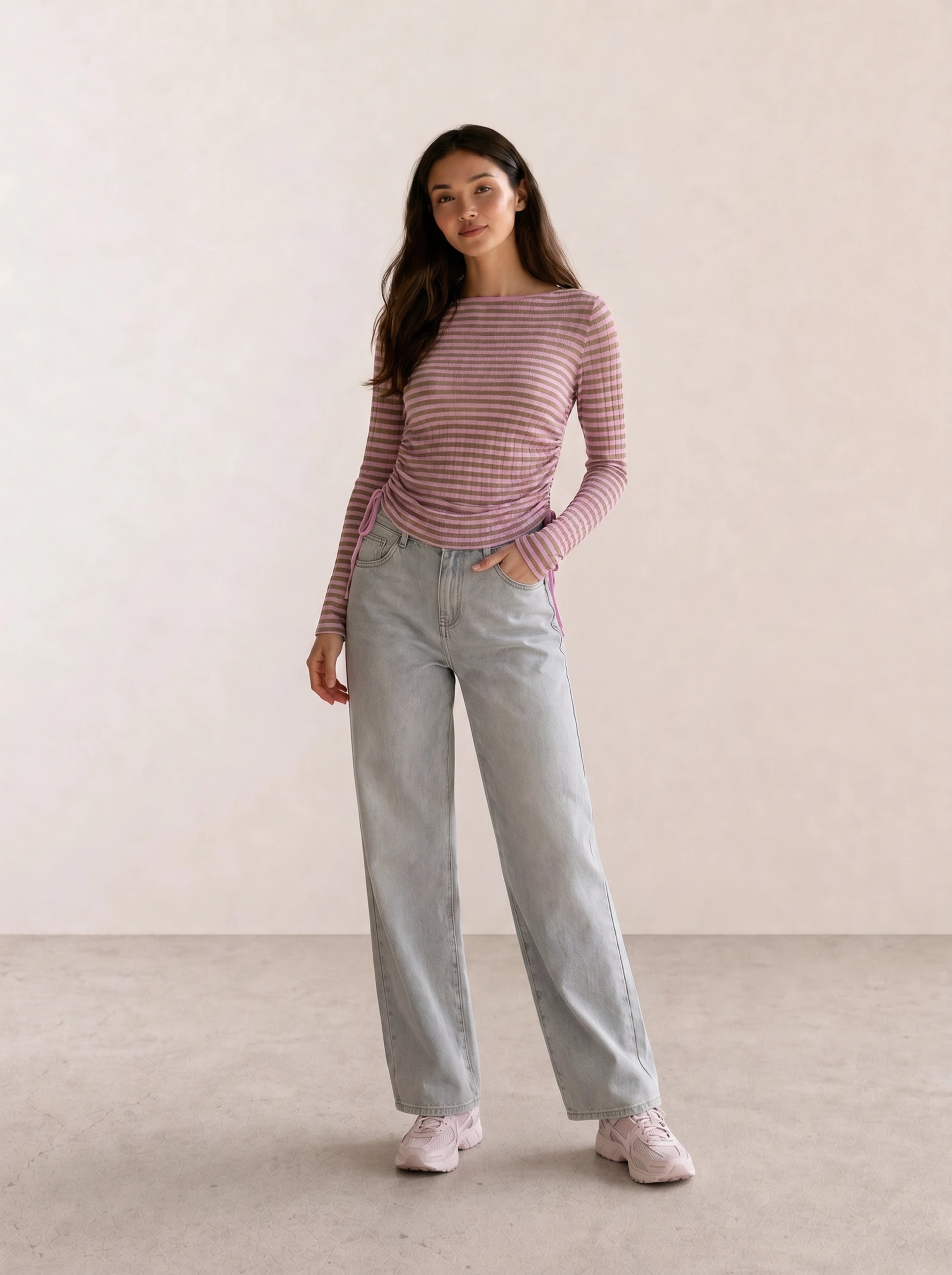 mauve striped ruched long-sleeve top with light wash wide-leg jeans and pale pink chunky sneakers — casual coquette spring outfit 2026