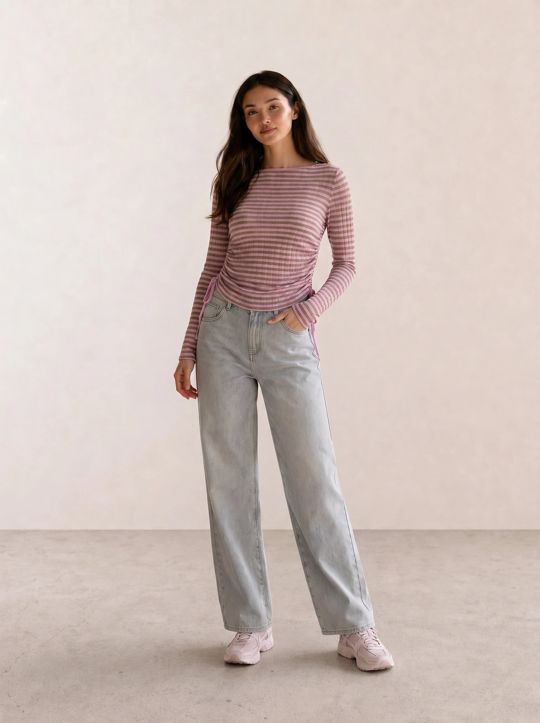 mauve striped ruched long-sleeve top with light wash wide-leg jeans and pale pink chunky sneakers — casual coquette spring outfit 2026