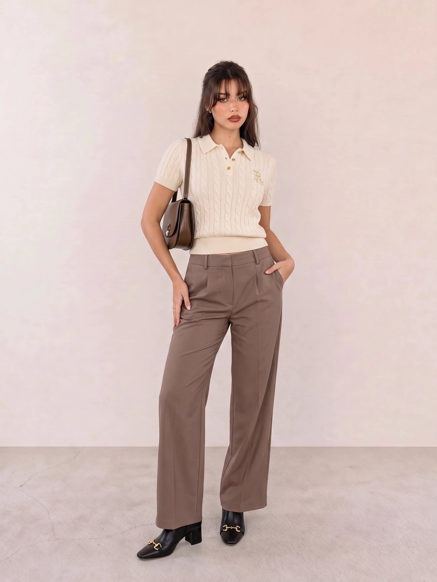 Old money look with ivory cable-knit polo top & brown wide-leg trousers and black gold-bit ankle boots