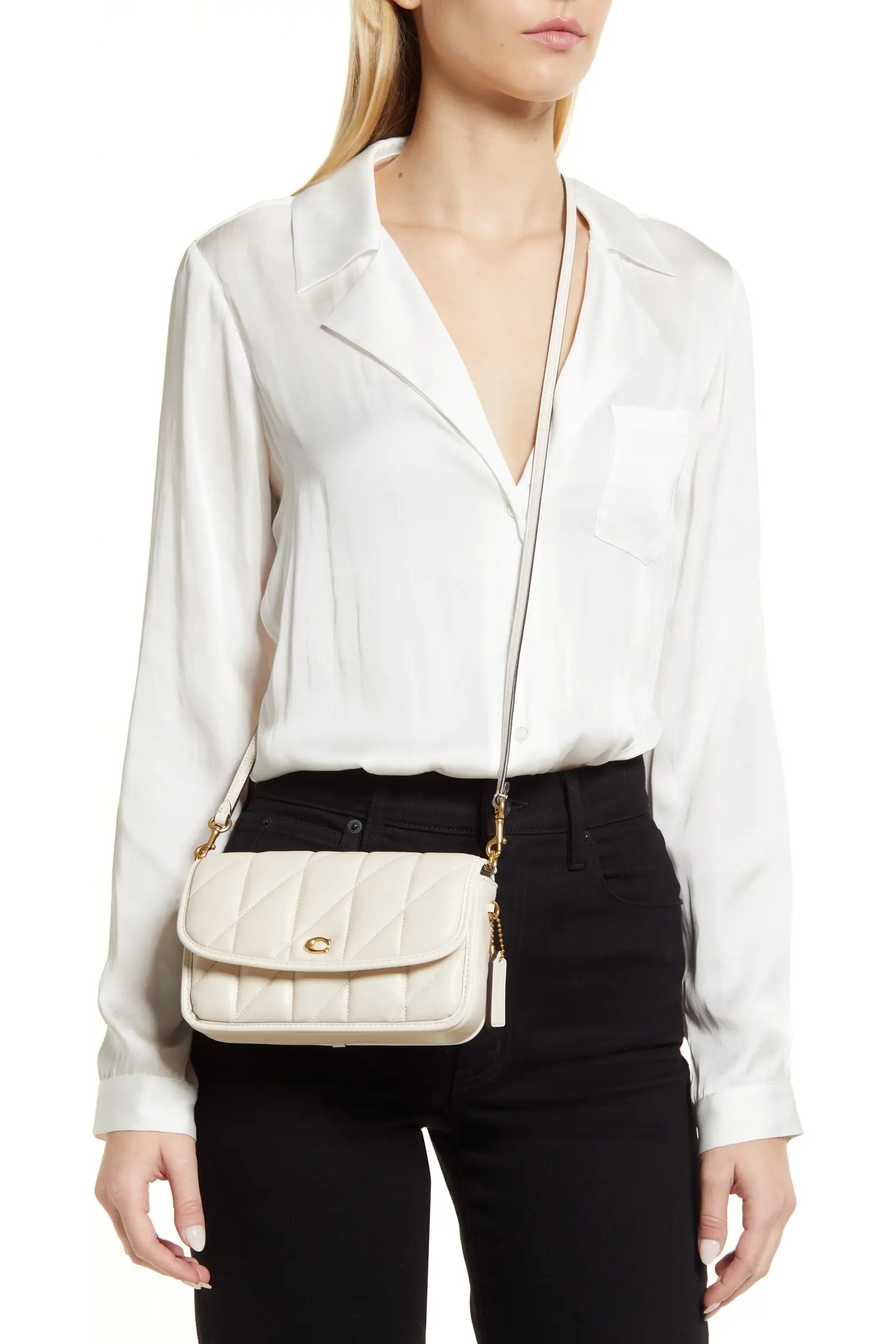 Ivory quilted crossbody bag styled with a blush corset top and denim mini skirt