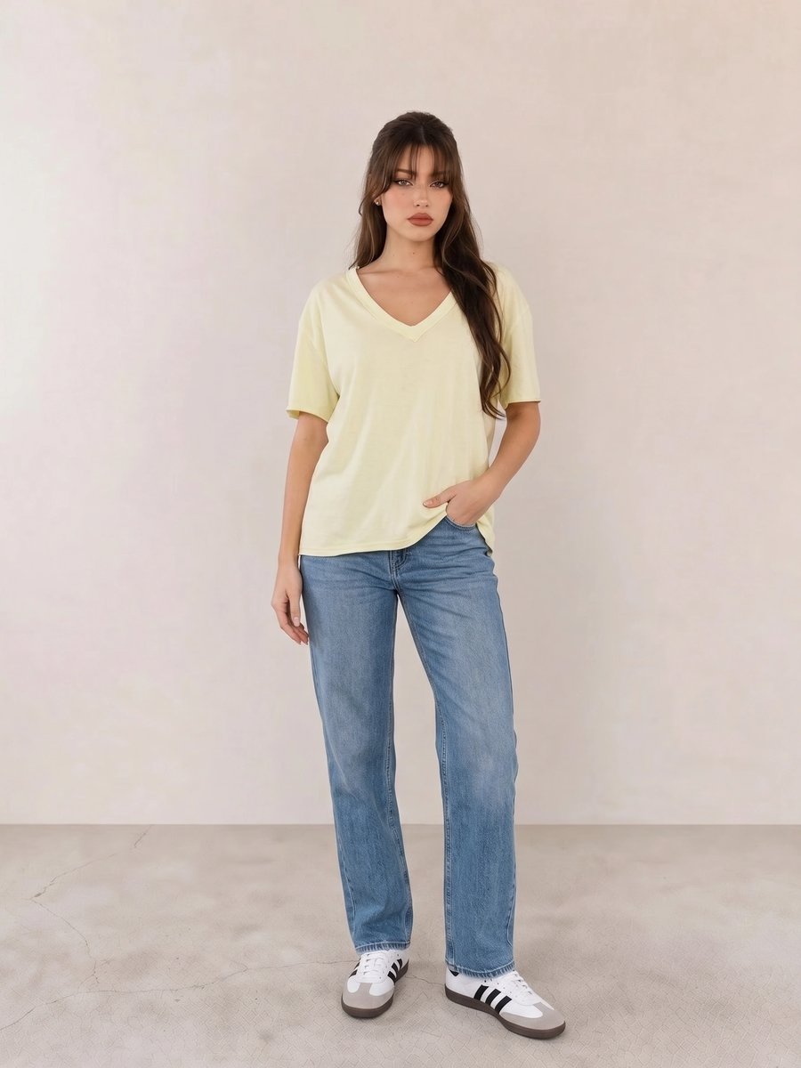 Basic casual outfit with a pale yellow V-neck tee, blue straight jeans, and white Adidas Samba sneakers