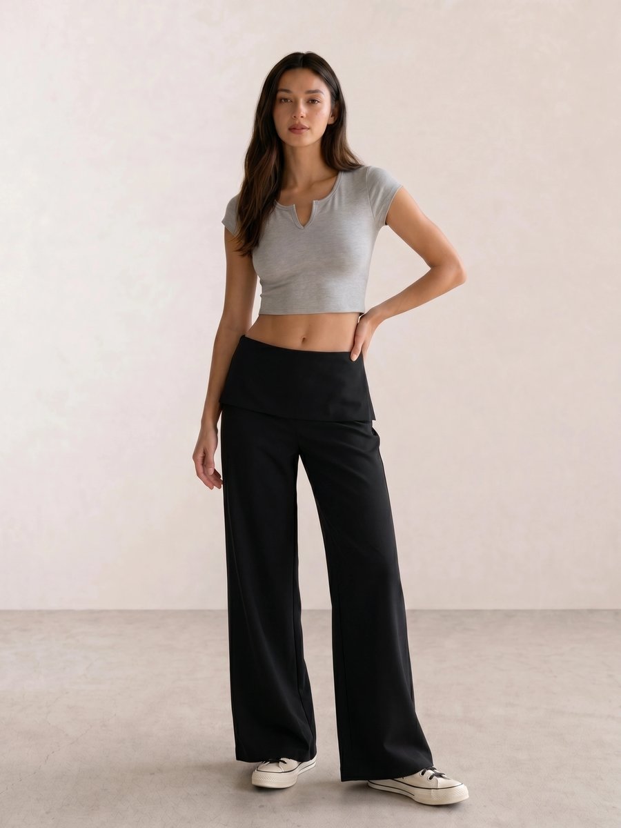Basic casual outfit with a grey notch-neck crop tee, black fold-over wide-leg pants, and cream Converse high-tops