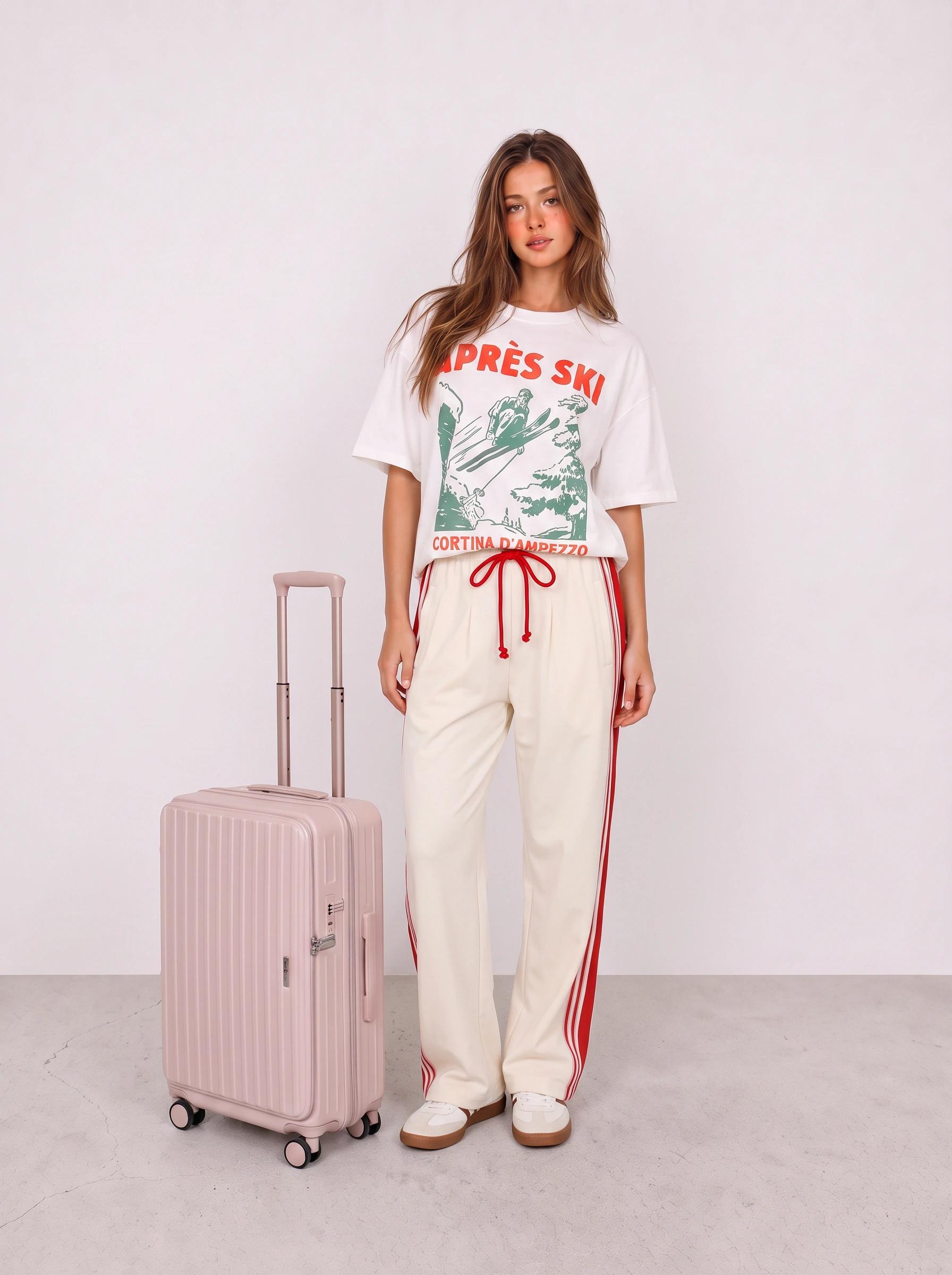 Graphic Tee and Cream Track Pants Airport Outfit