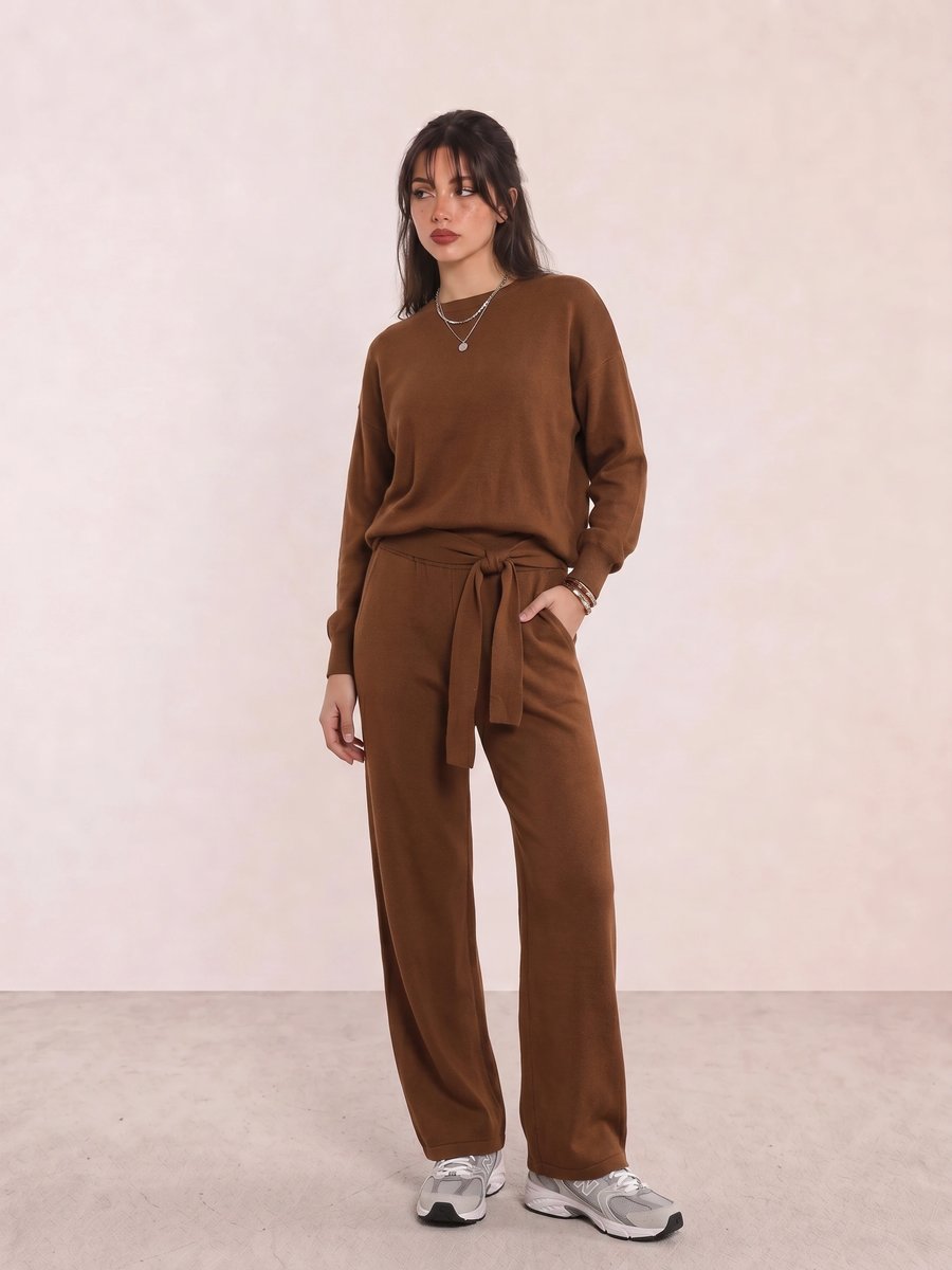 Korean fashion outfit with a brown knit sweater and matching trousers, worn with grey running sneakers
