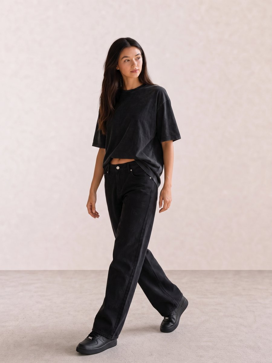 All-black casual outfit with an oversized washed tee, baggy black jeans, and black sneakers