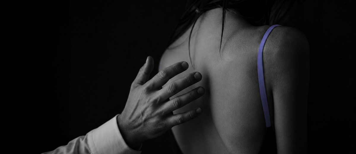 Woman turned away from a man's reaching hand in moody black and white, evoking the question of whether to forgive a partner for cheating