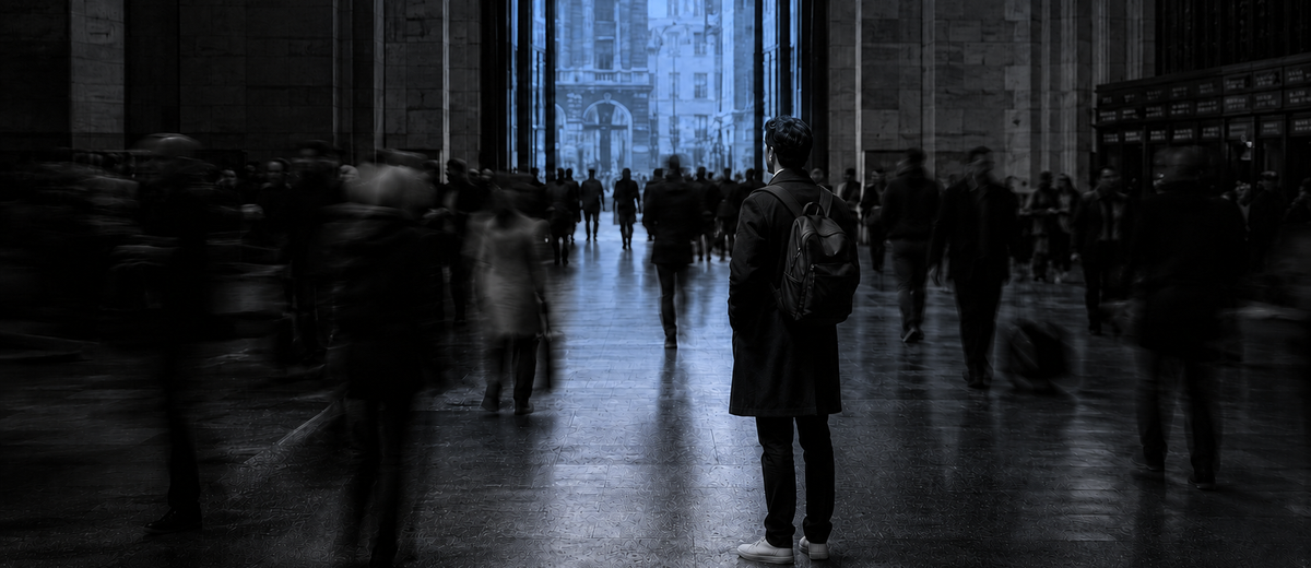 Man standing motionless in a blurred, moving crowd, illustrating the isolation emotional support is meant to address