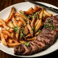 Pièce de bœuf tranchée servie avec des frites maison