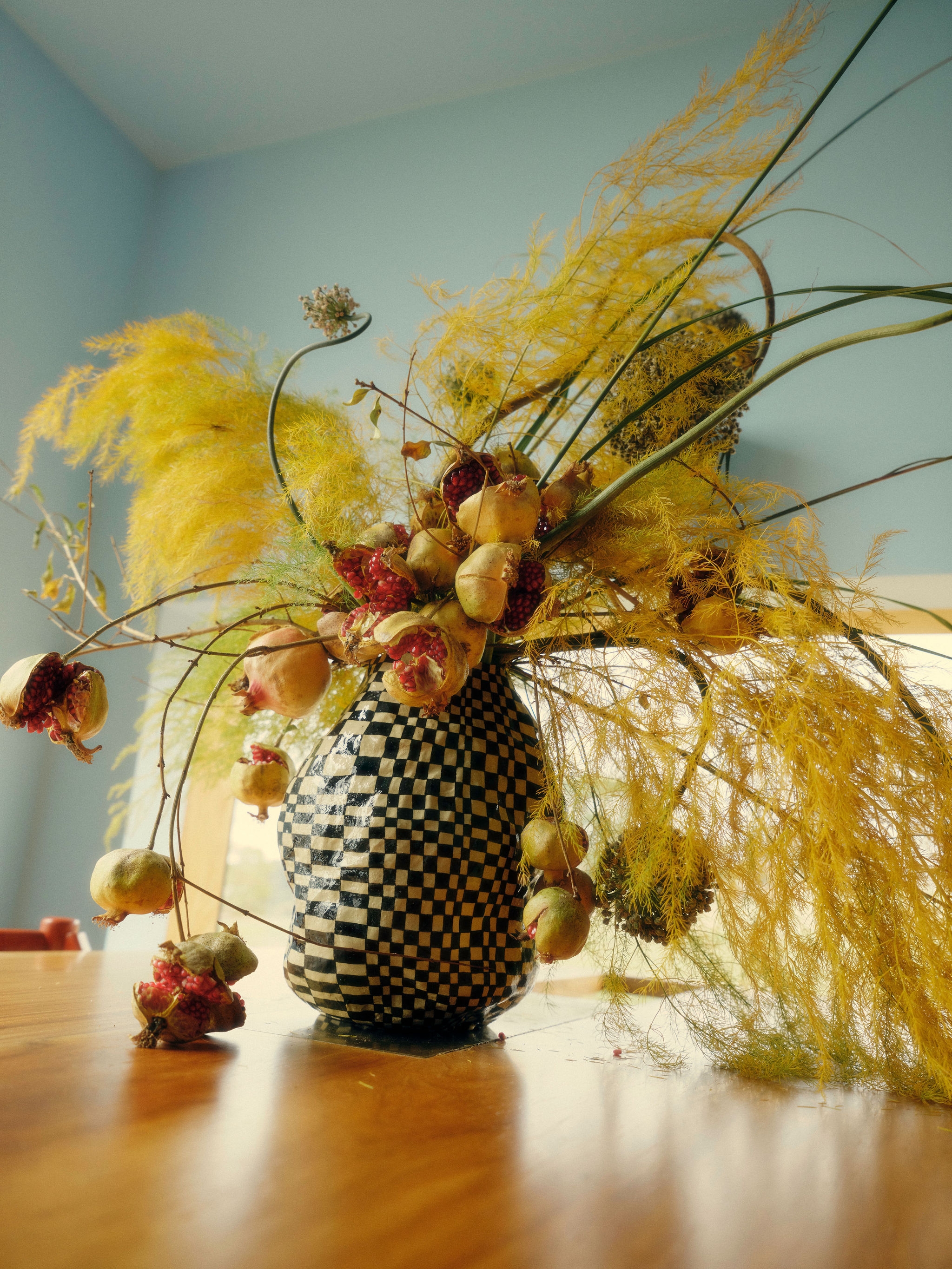 A room with a bicycle, a dresser, and paintings on the wall