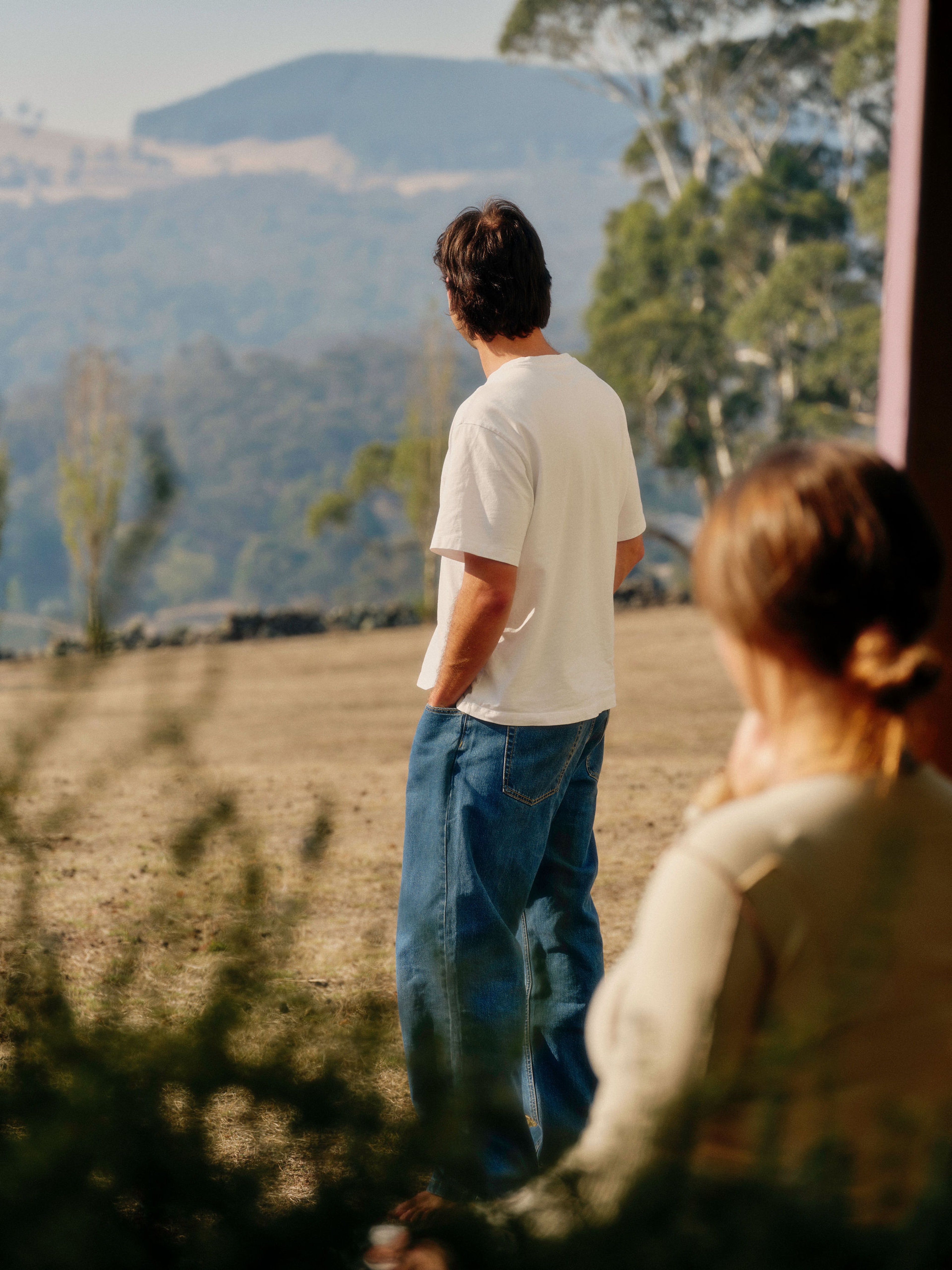 A striped wall tapestry and cream couch in a living room