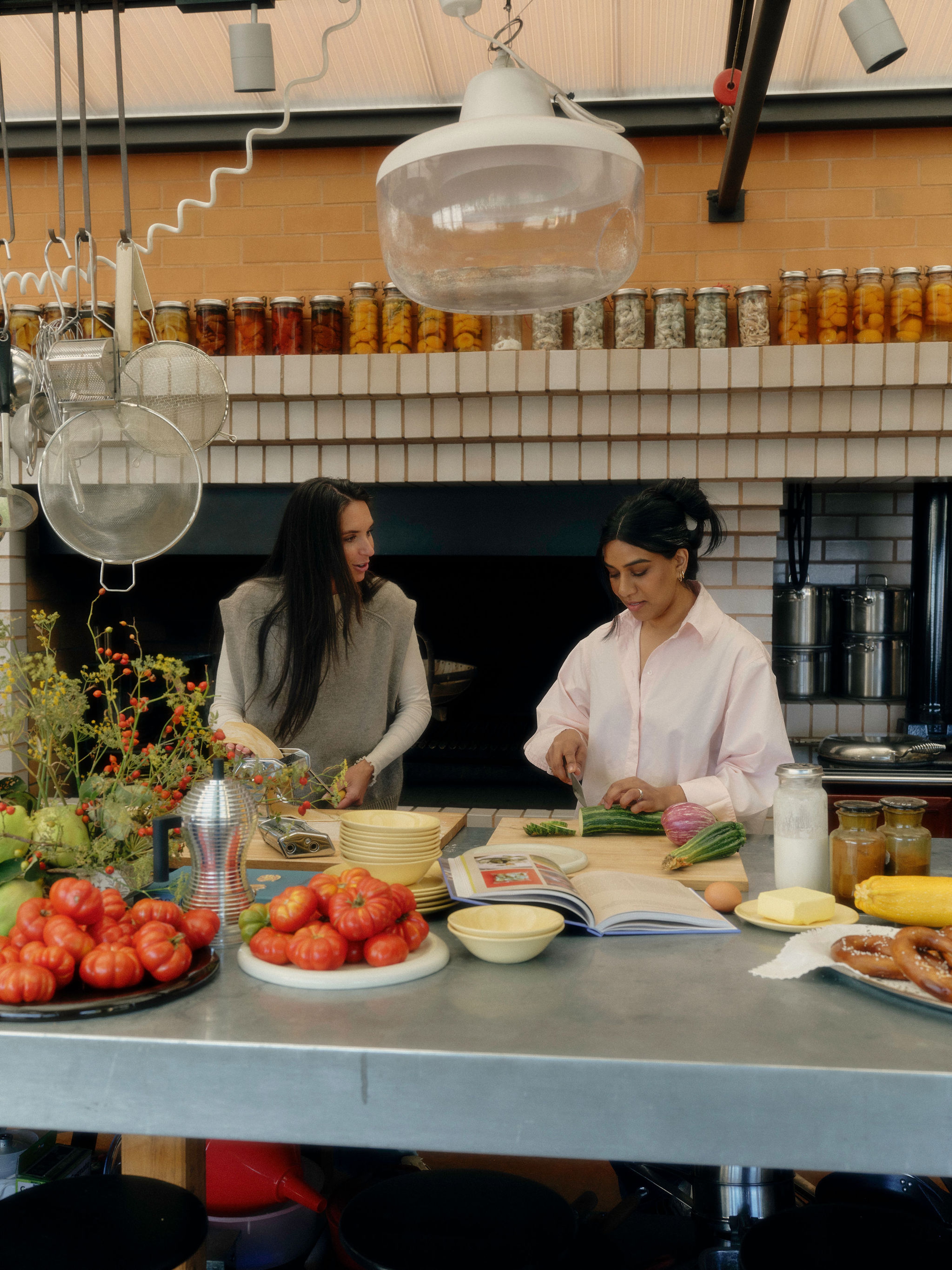 two women in the kitchen cooking