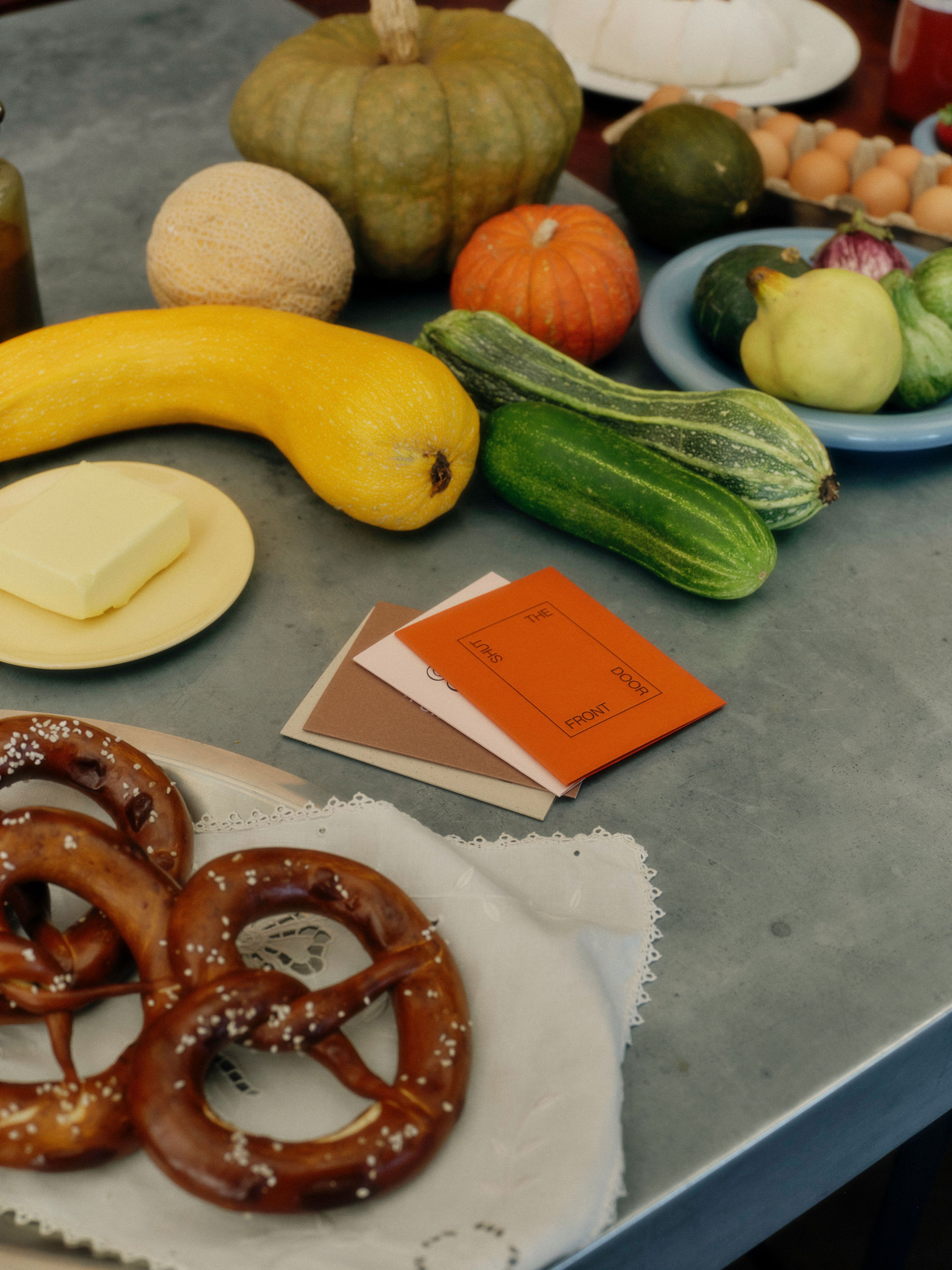 Four friends celebrate together with around a table of food and gifts