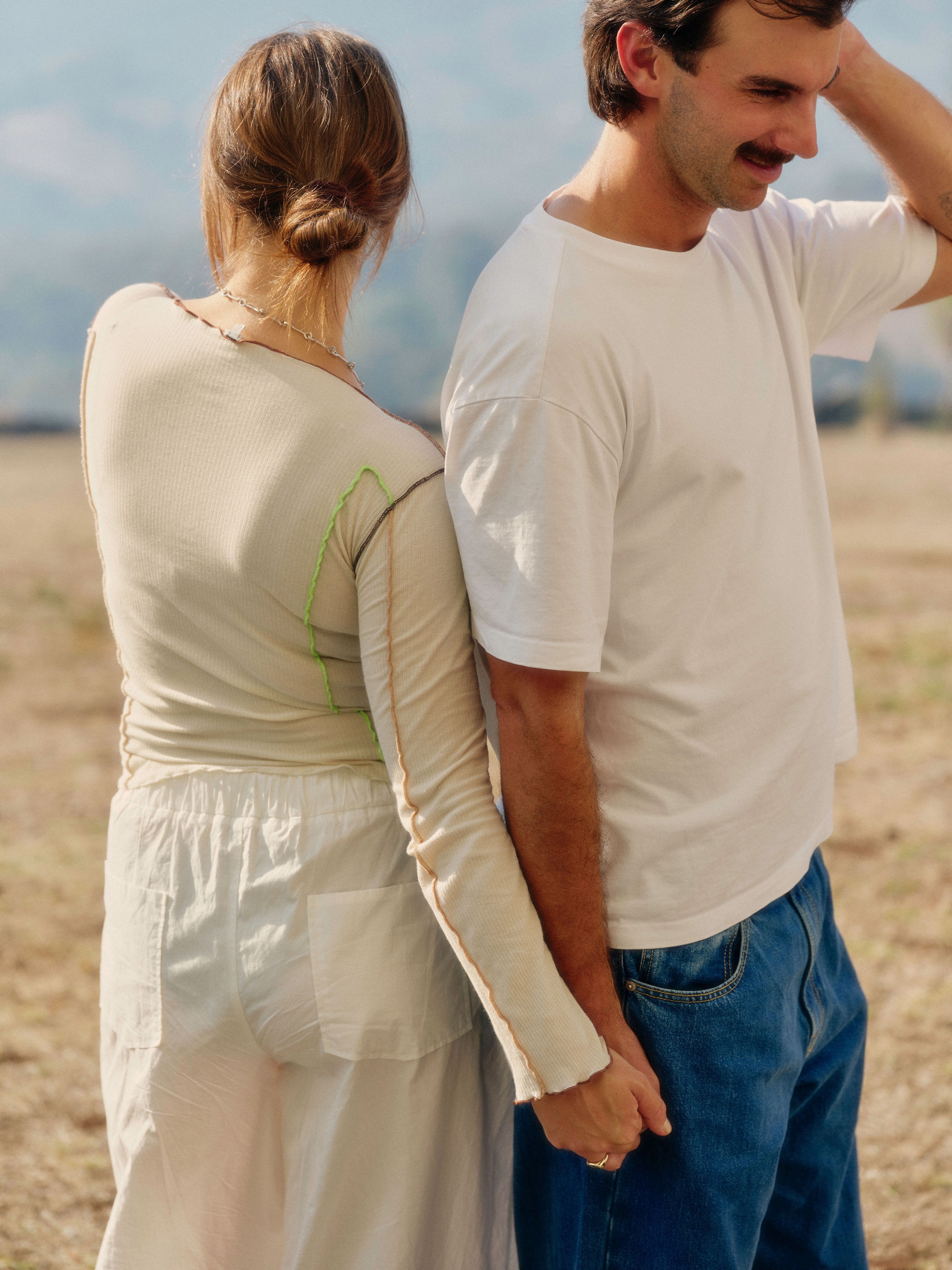A striped wall tapestry and cream couch in a living room