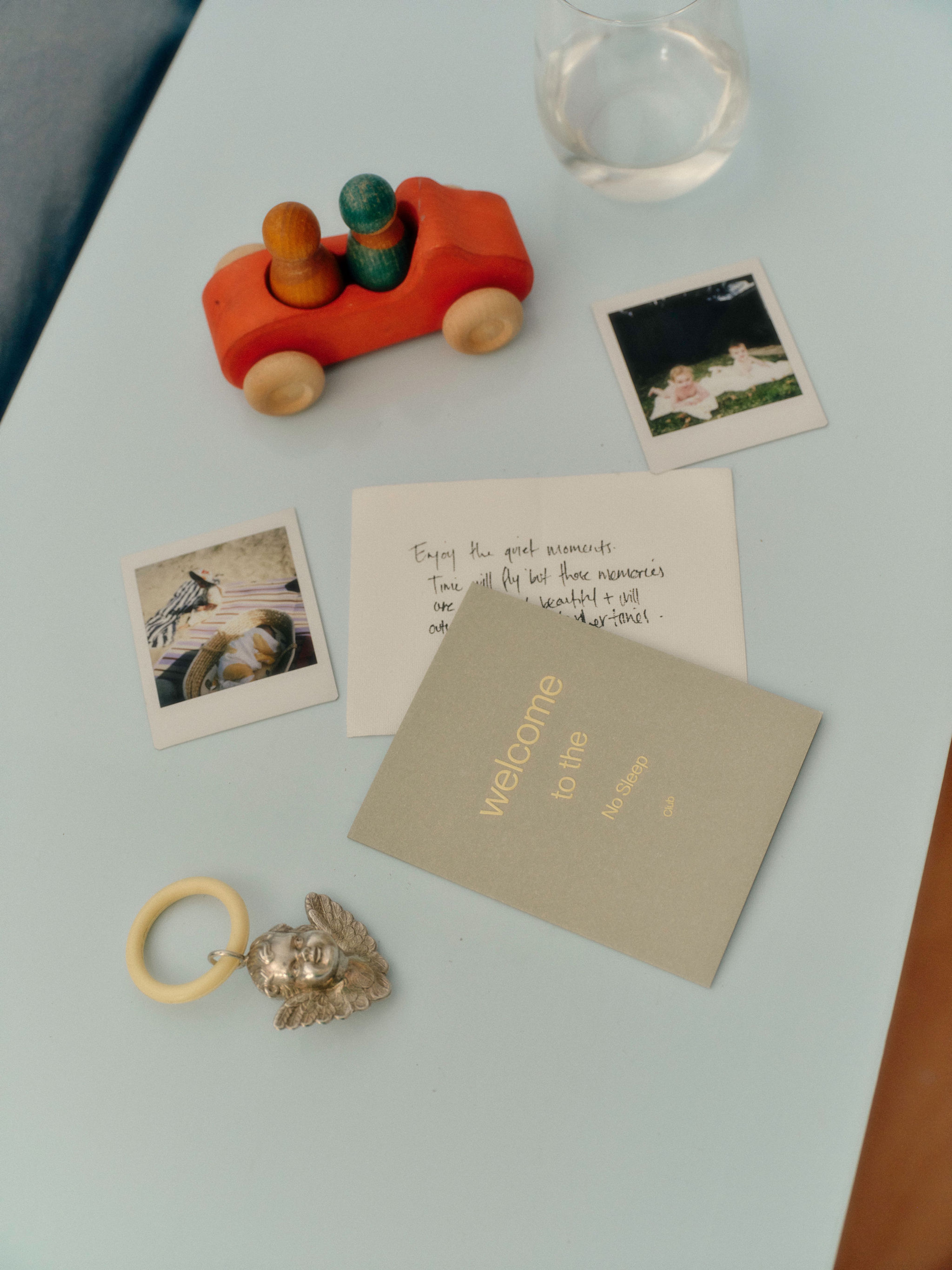 A baby's hand on their father's hand