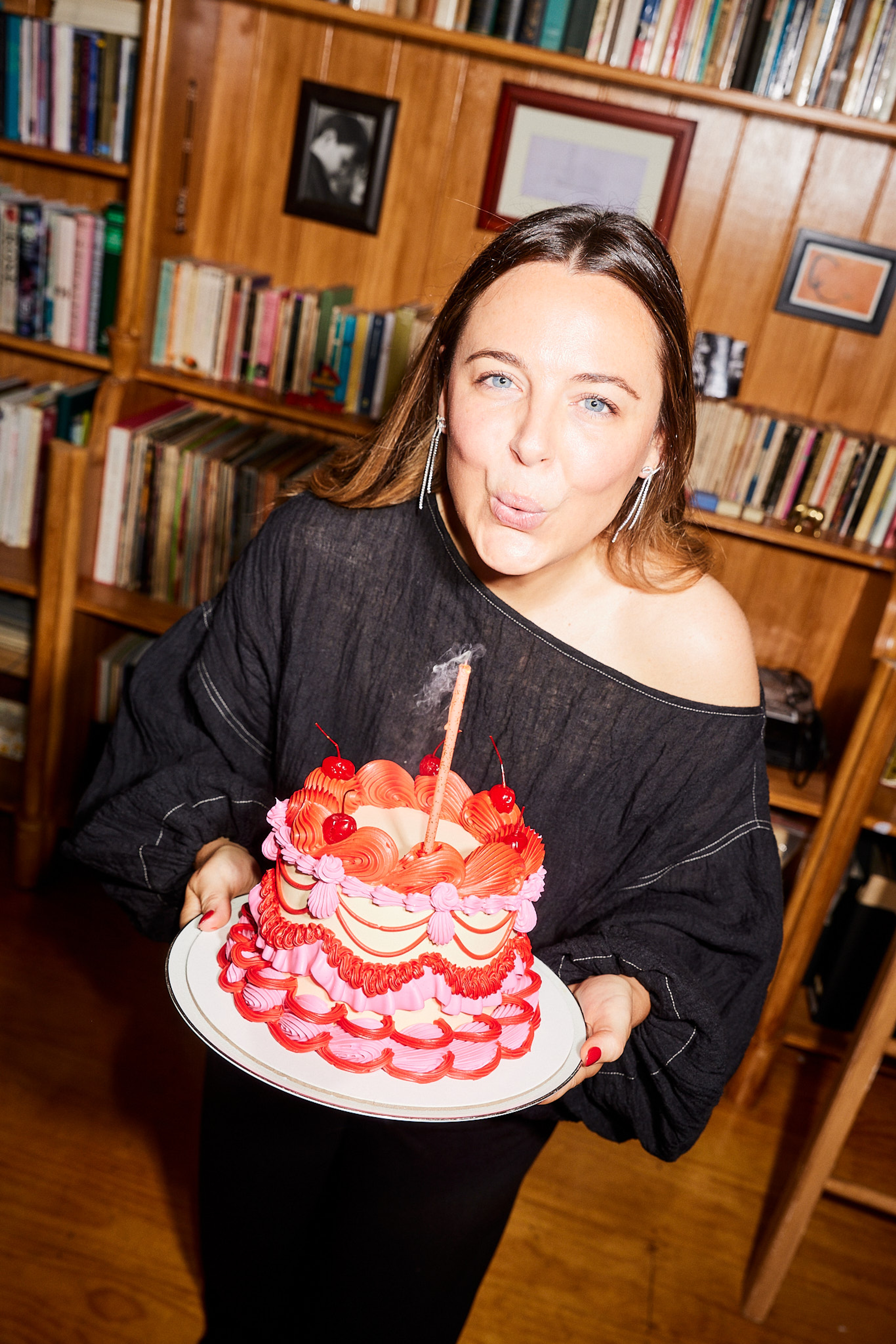 Founder of Short Talk blowing out a candle on cake