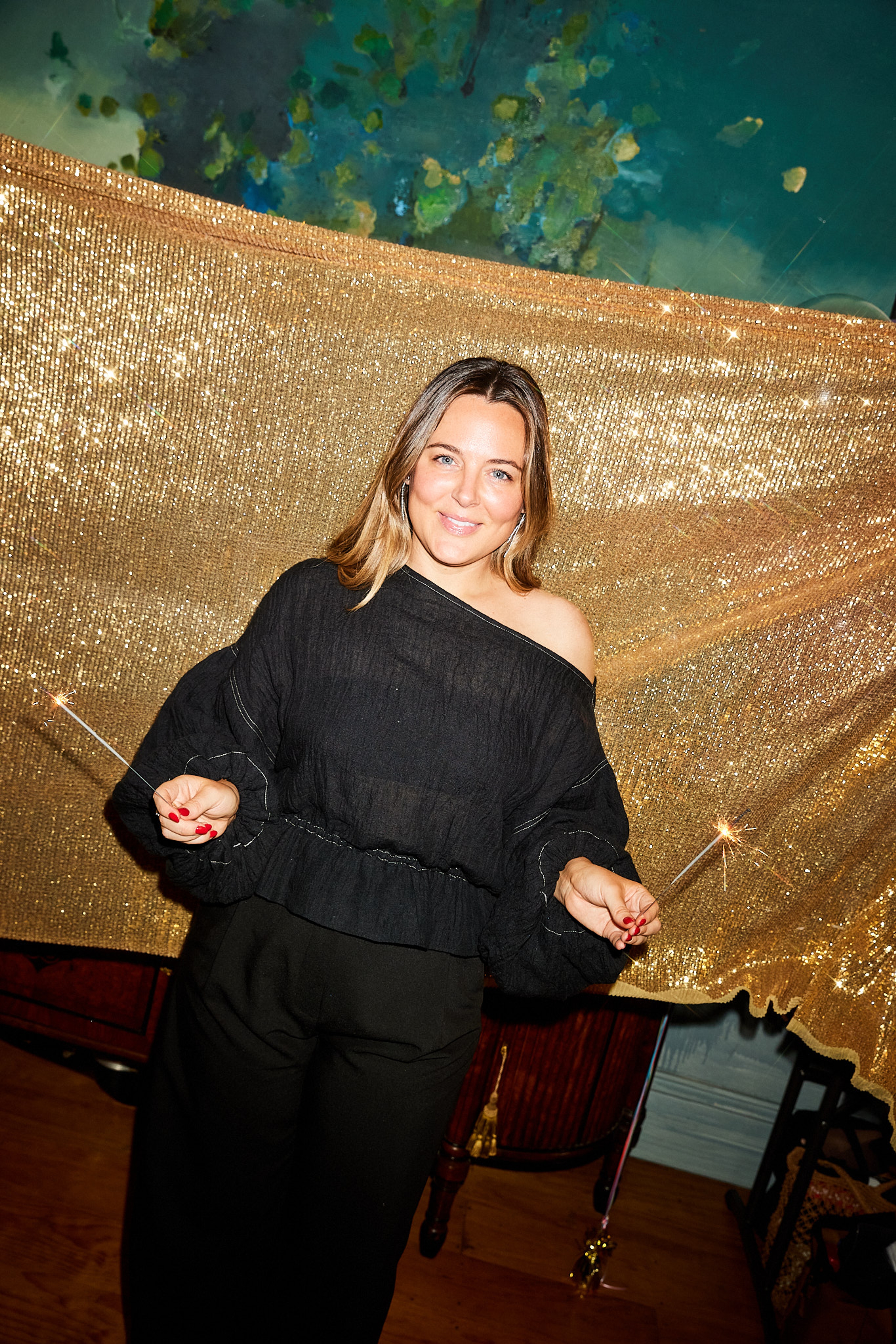 Jess waving sparklers on set