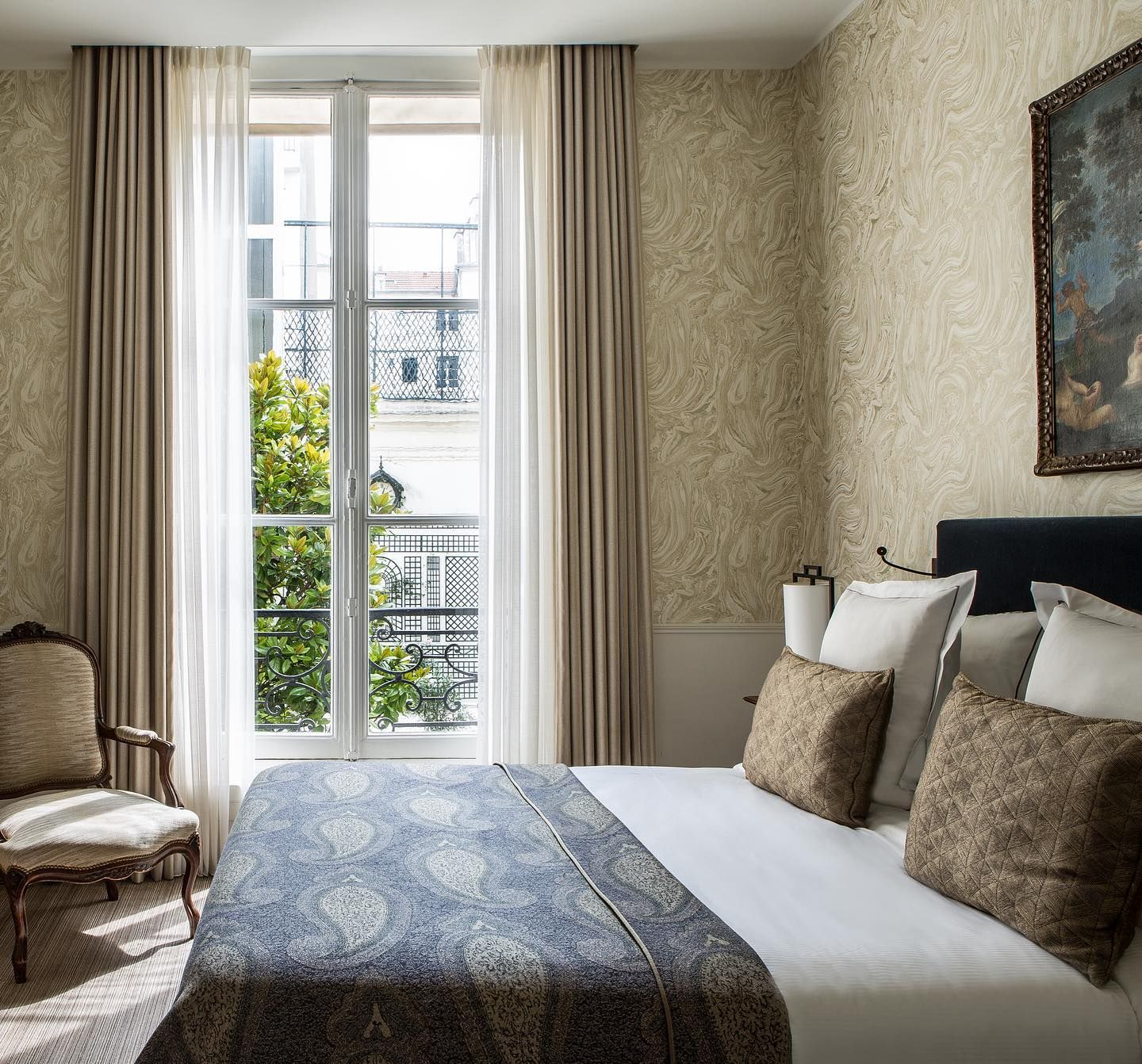 Luxurious curtains framing tall window with a great view from Hotel des Saints Peres, Paris  