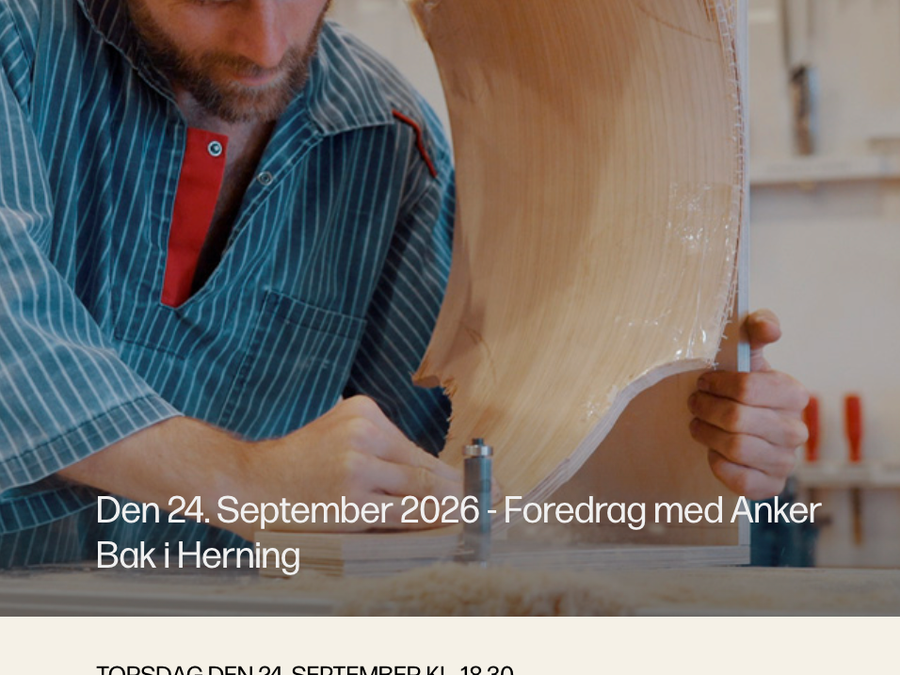 Anker Bak works on a curved wooden object in his workshop