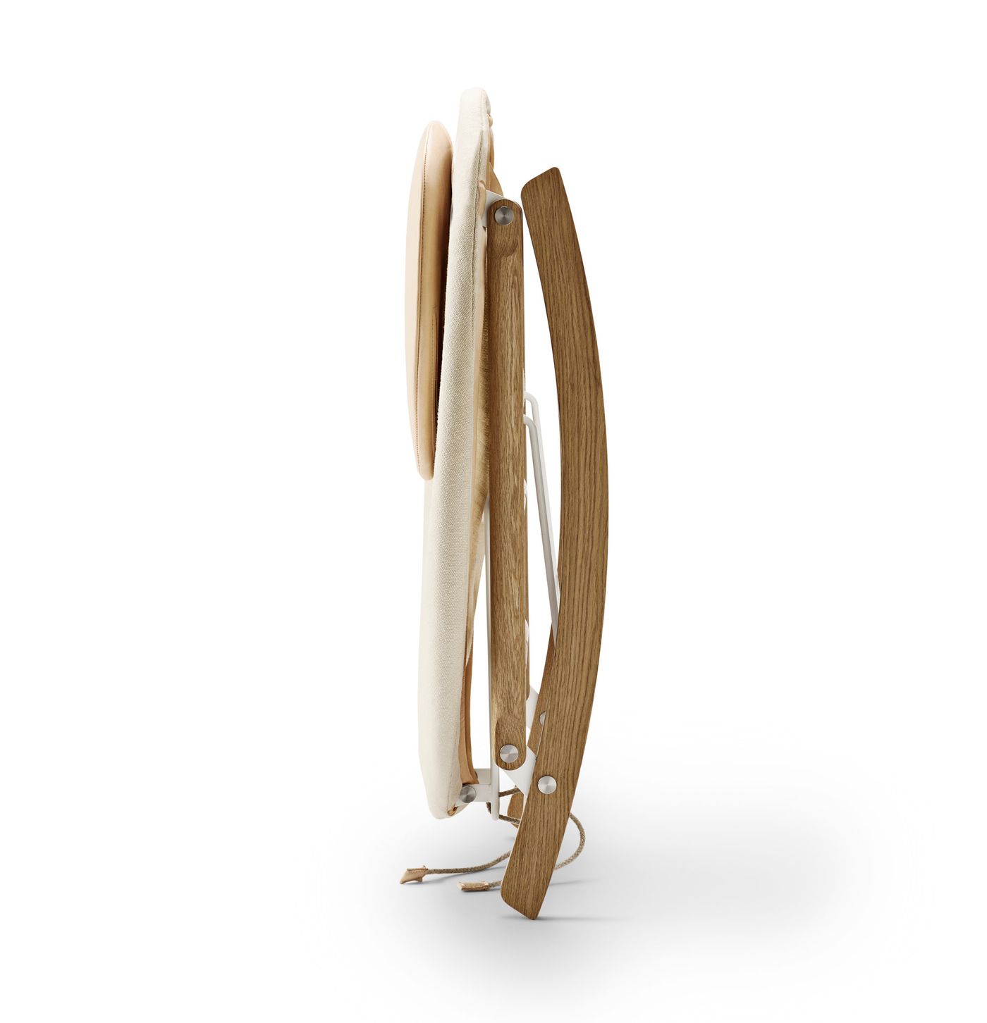 Rocking Nest Chair by Carl Hansen & Søn — a foldable rocking chair in walnut wood with a suspended canvas seat and steel cable details, shown in profile on a white background.