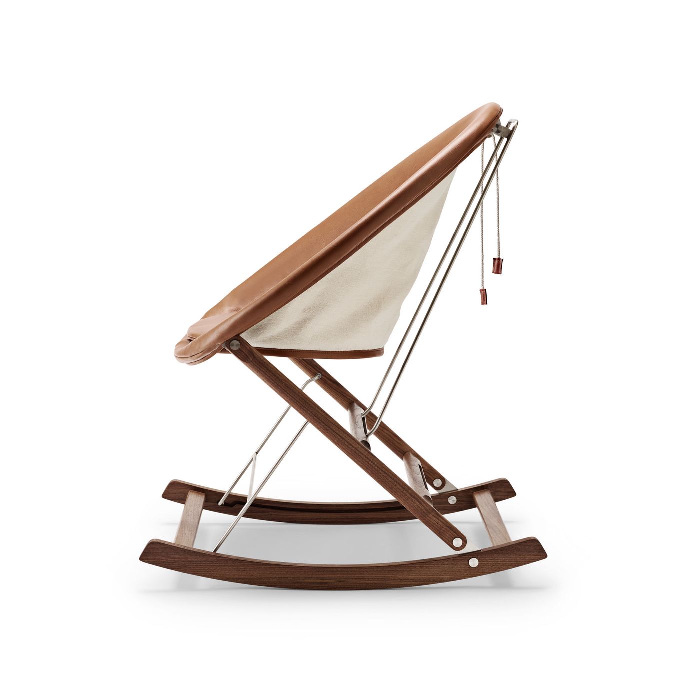 Rocking Nest Chair by Carl Hansen & Søn — a foldable rocking chair in walnut wood with a suspended canvas seat and steel cable details, shown in profile on a white background.