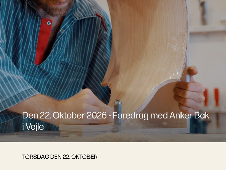 Anker Bak works on a curved wooden object in his workshop
