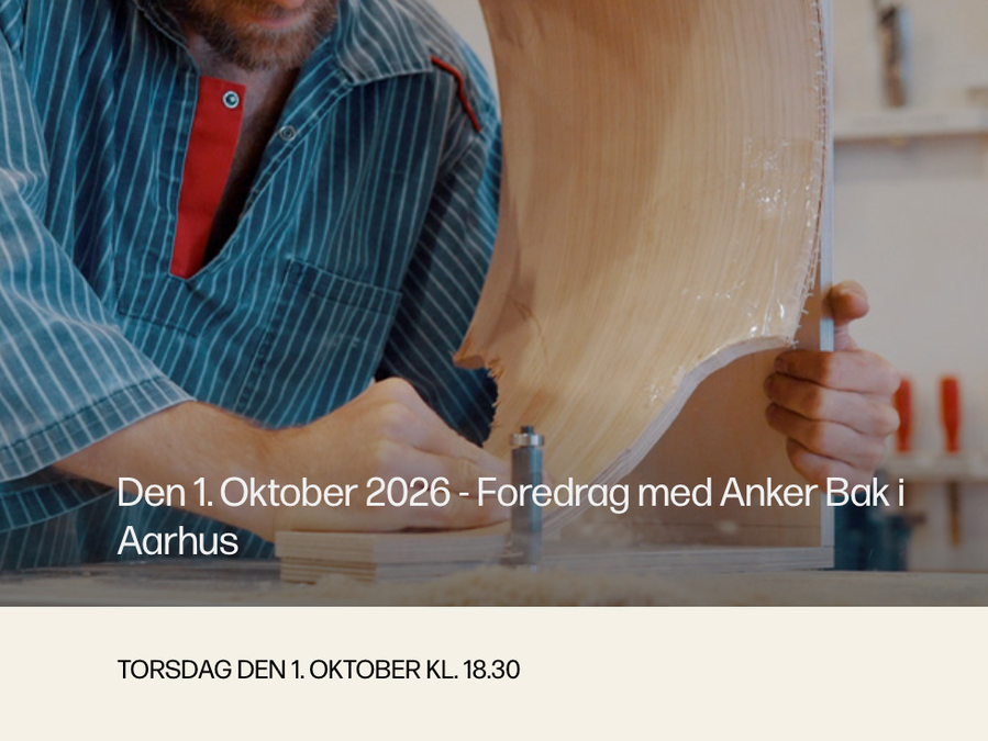 Anker Bak works on a curved wooden object in his workshop
