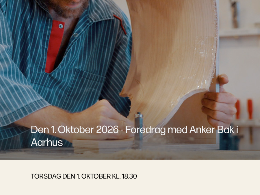 Anker Bak works on a curved wooden object in his workshop