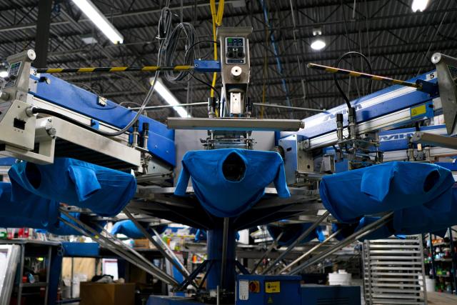 Close-up of a blue screen printing machine