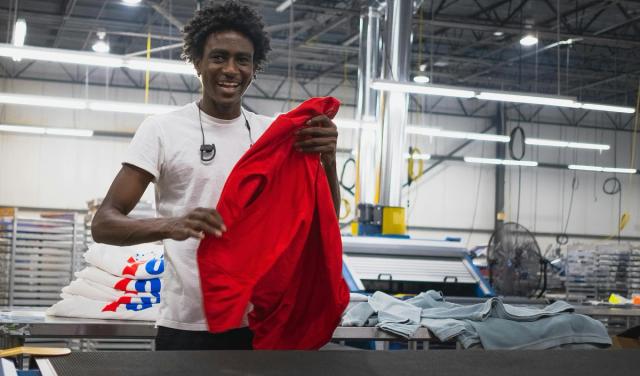 A man holding a red t-shirt