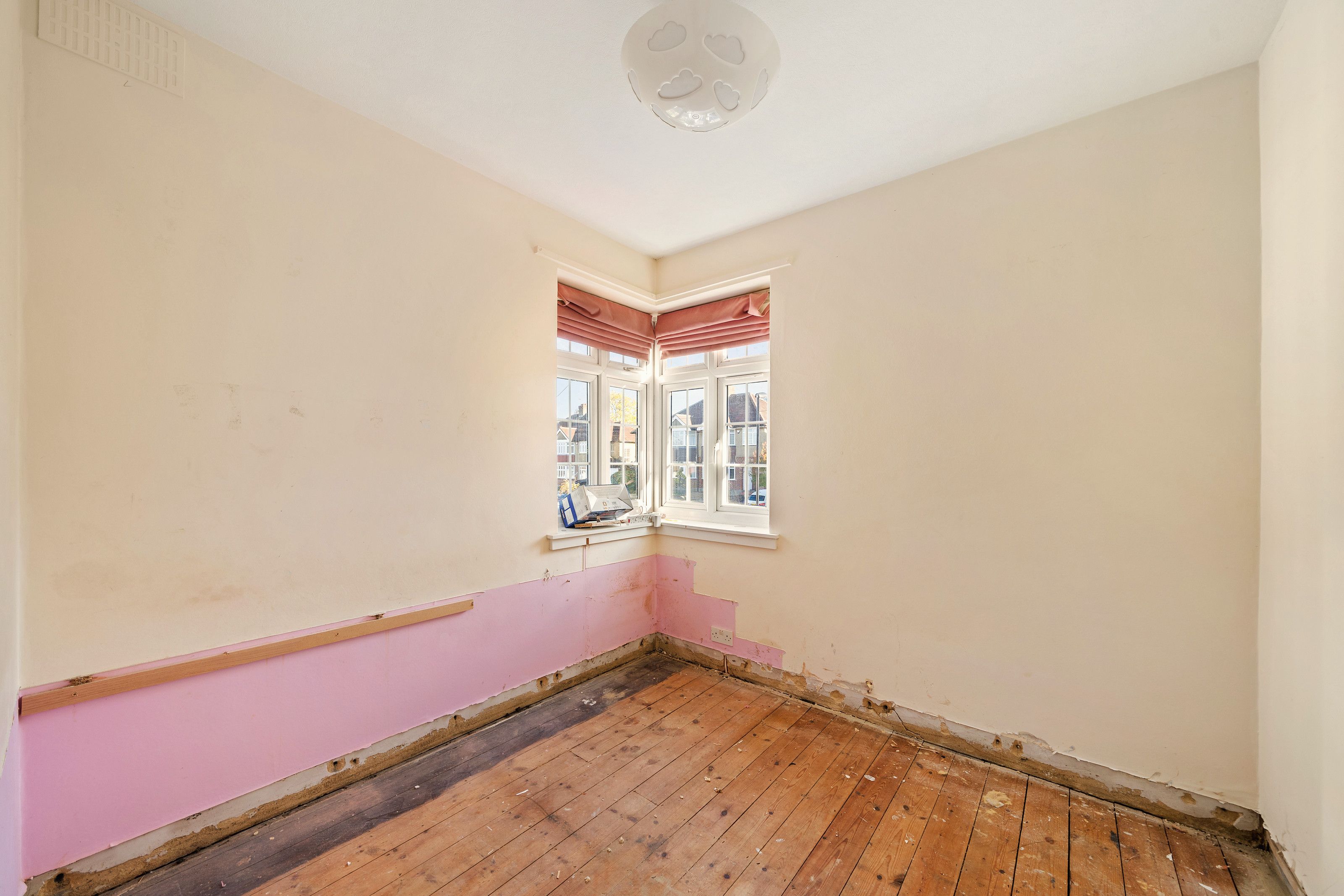 Bedroom with corner window before the work