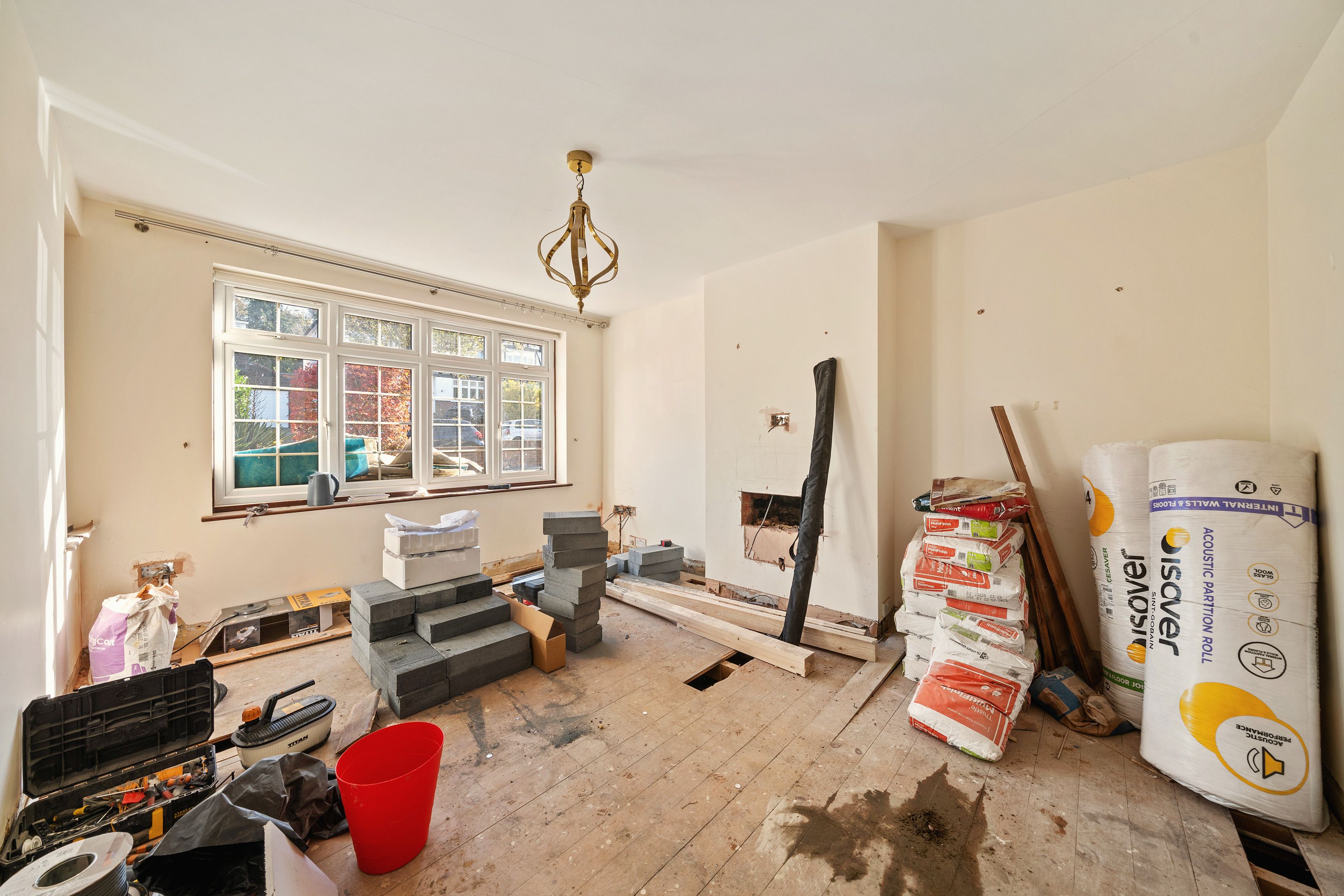 Room before the work with building materials stacked on the floor