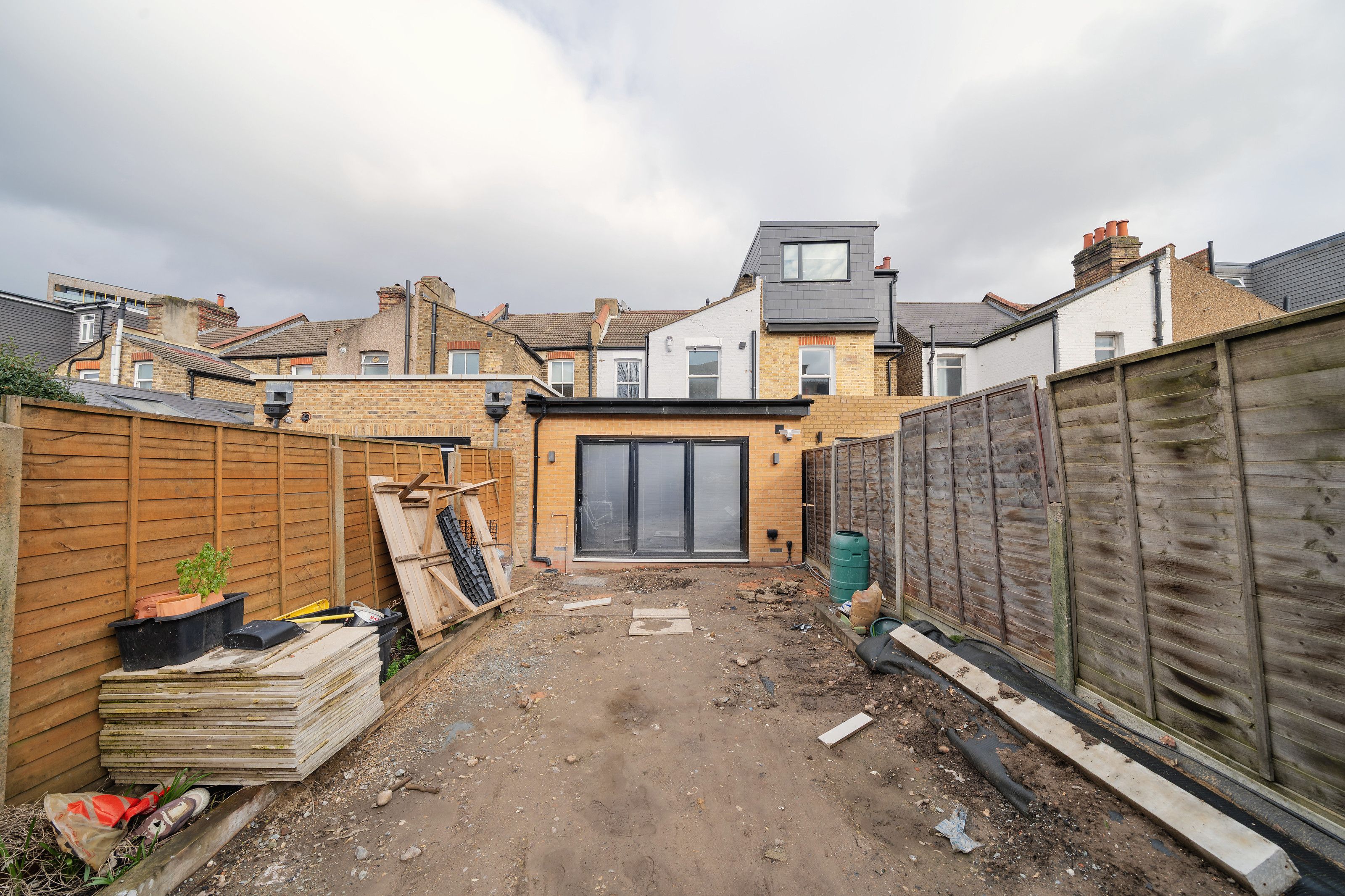 Looking down the garden to the new extension, with building materials still in the garden