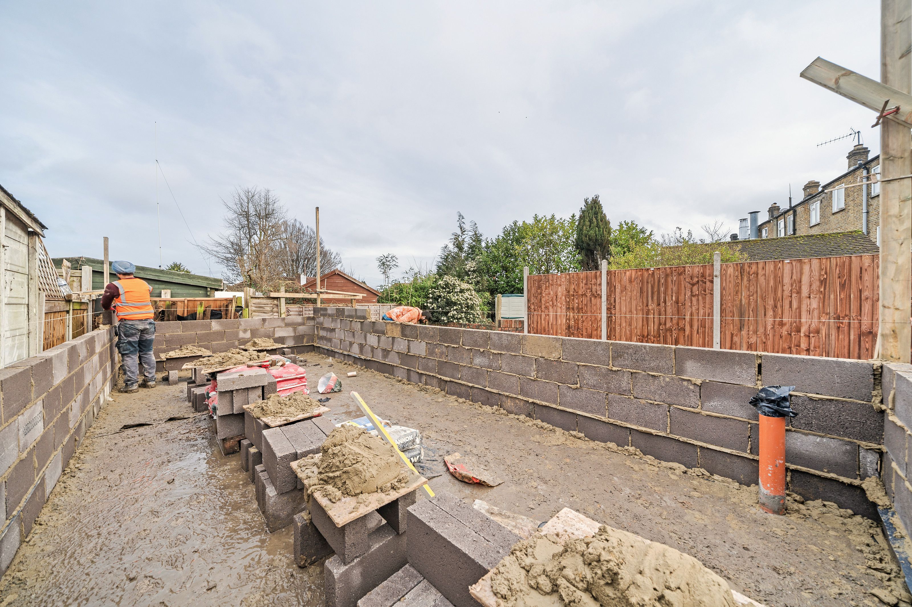 Builders at work on the new blockwork walls in the garden