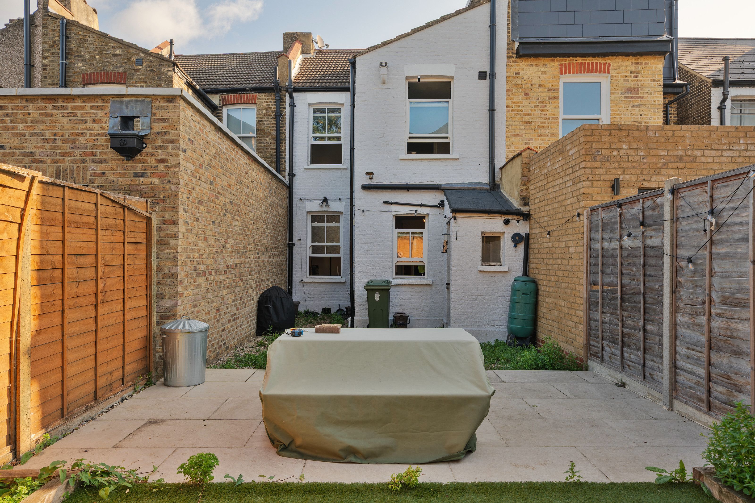 The back of the house before the work, with its original white-painted back addition between the neighbours