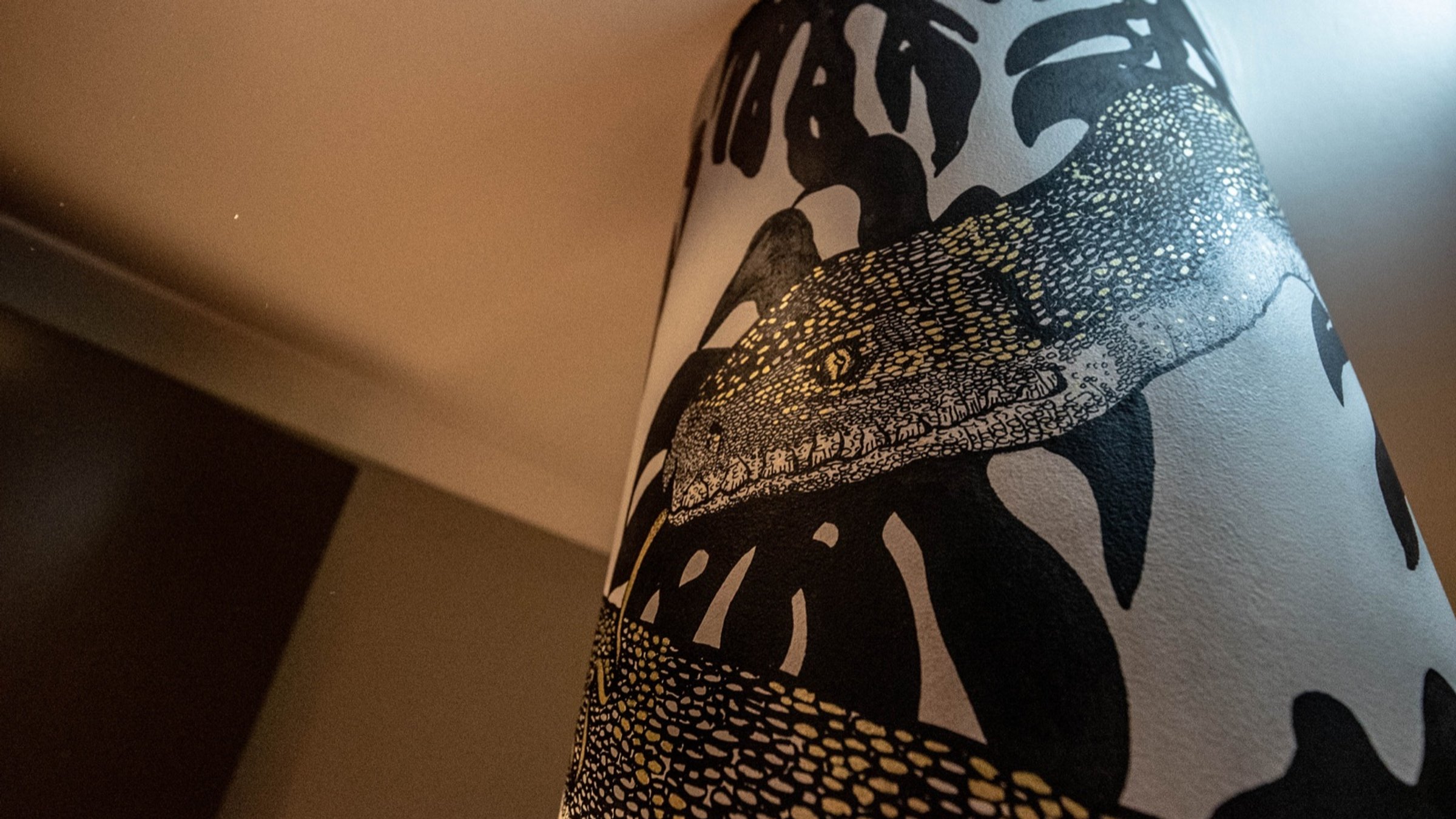 Detail of the crocodile and palm wallpaper inside Holmes Hotel London
