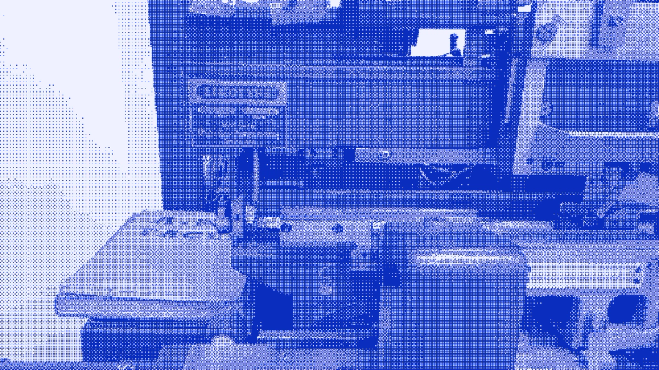 A Linotype typesetting machine seen close up, its castings and levers filling the frame.