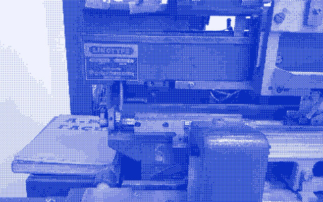 A Linotype typesetting machine seen close up, its castings and levers filling the frame.