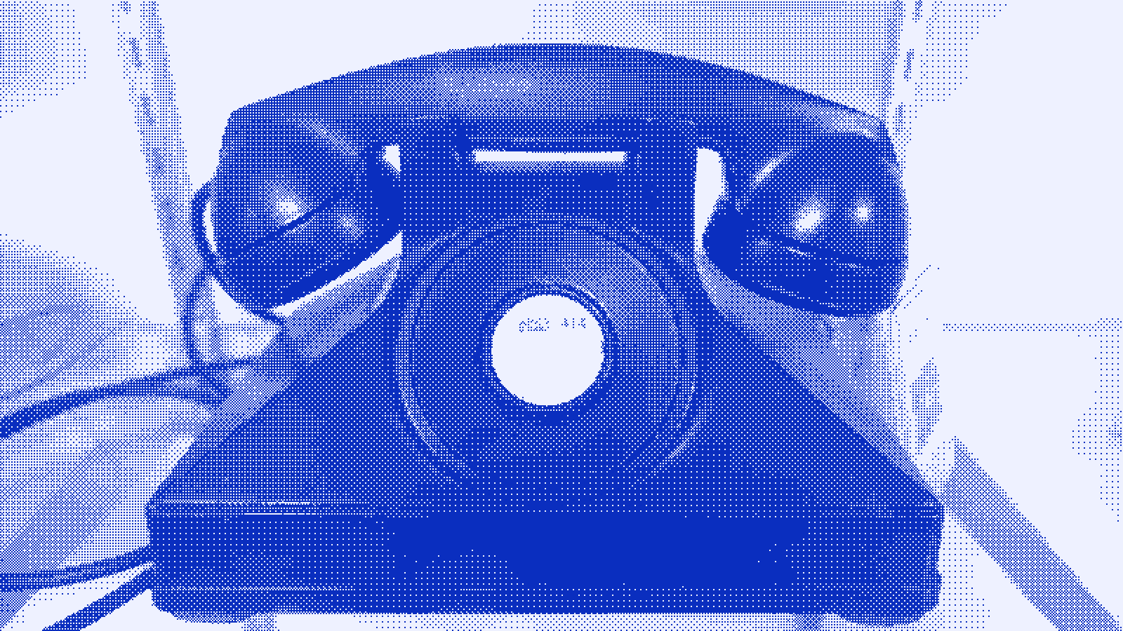 A Bakelite rotary-dial telephone with its handset resting in the cradle.