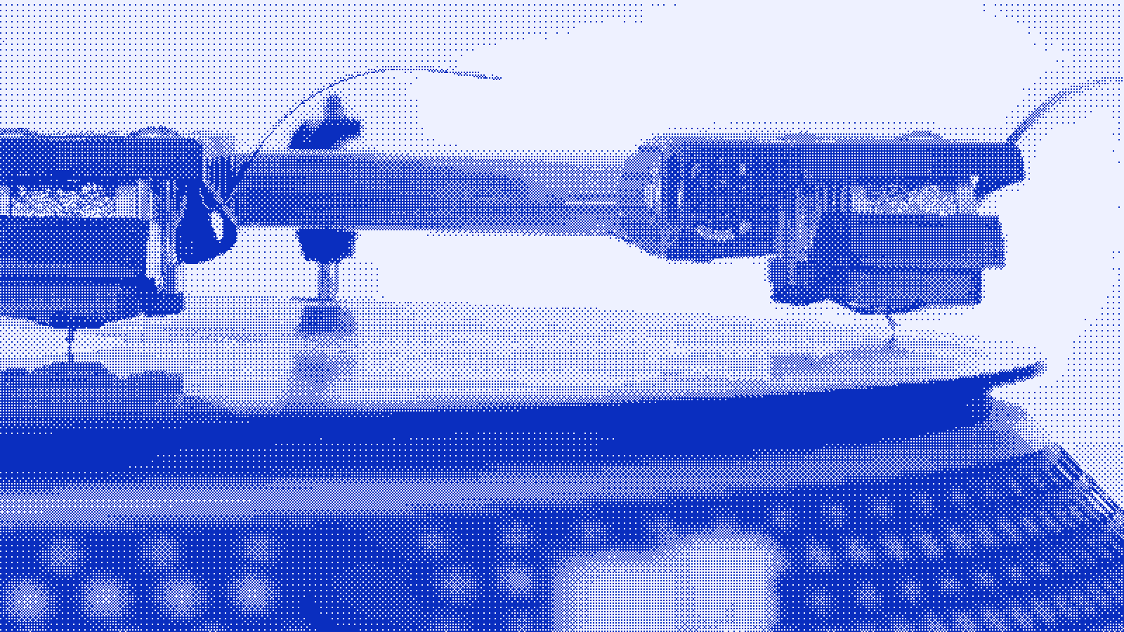 An extreme close-up of a stylus riding in the groove of a vinyl record.