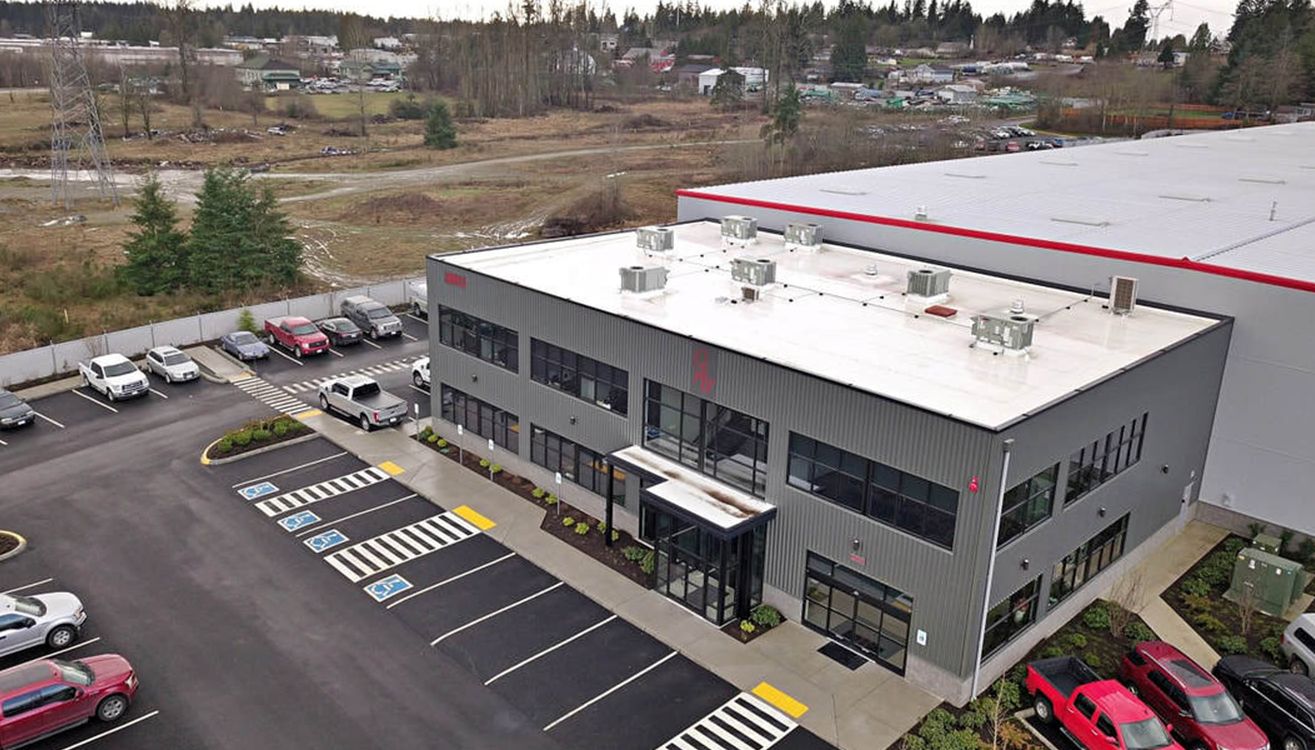 Aerial view of the office entrance, parking, and manufacturing building.