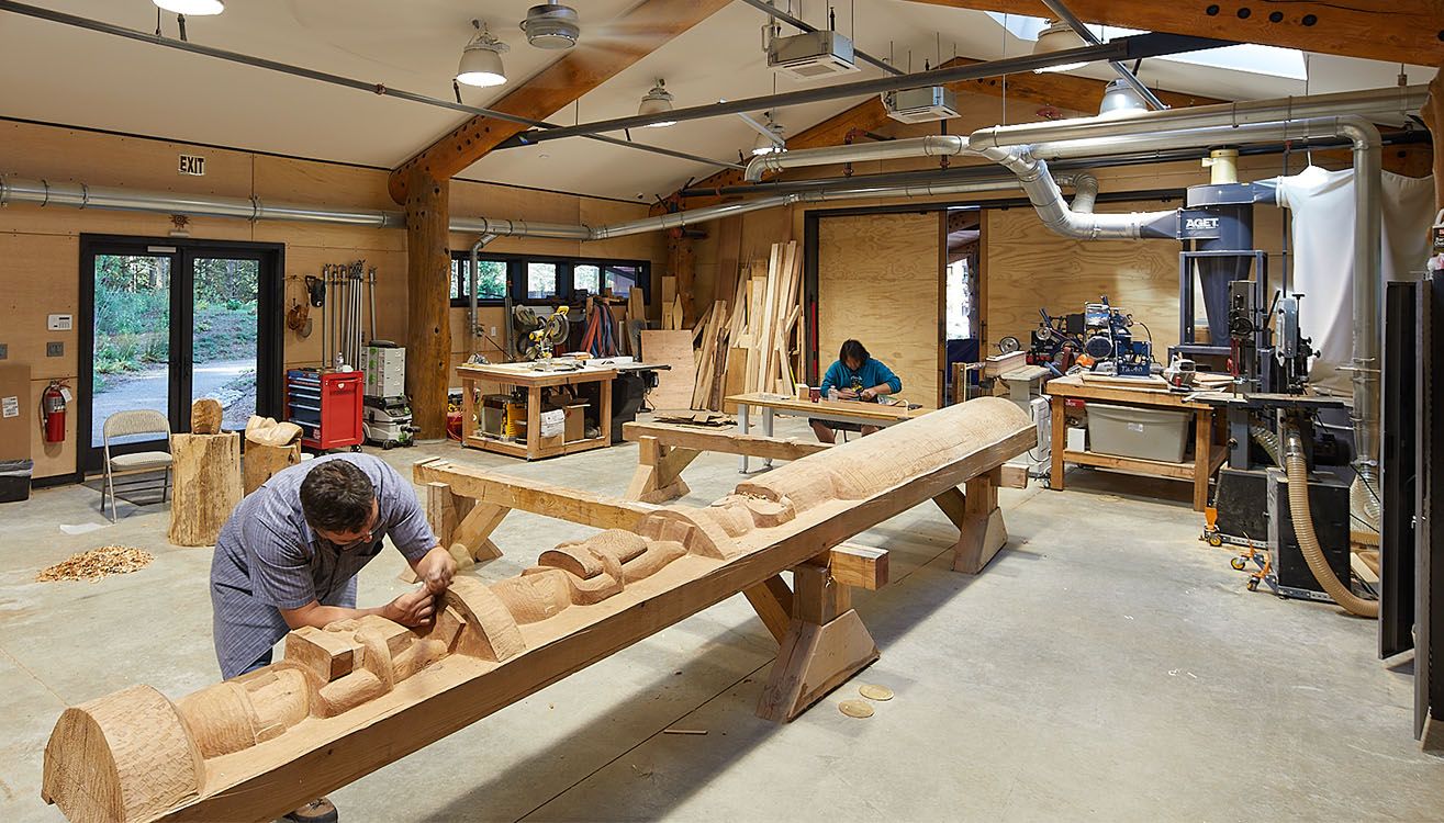 Carvers at work inside the canoe carving workshop