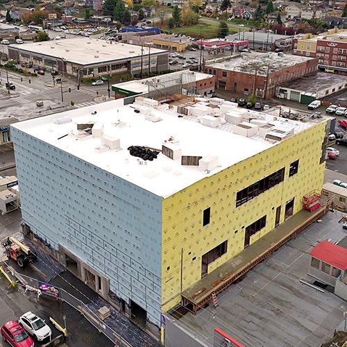 Museum addition with roof installed and exterior sheathing underway