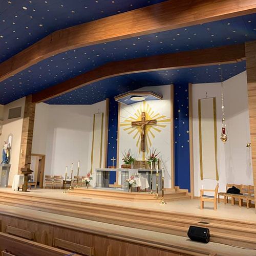 Altar beneath the timber beams and blue star-patterned ceiling