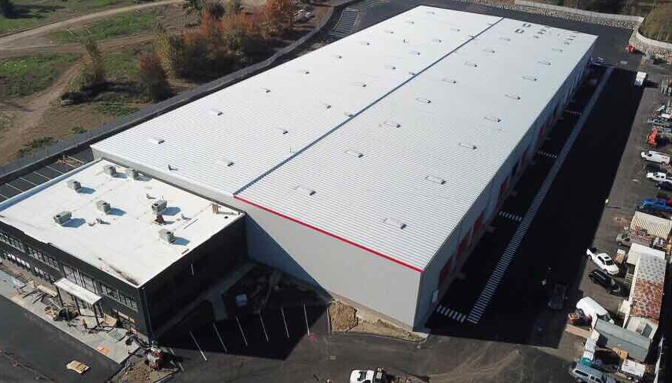 Aerial view of the manufacturing building and adjoining office wing.