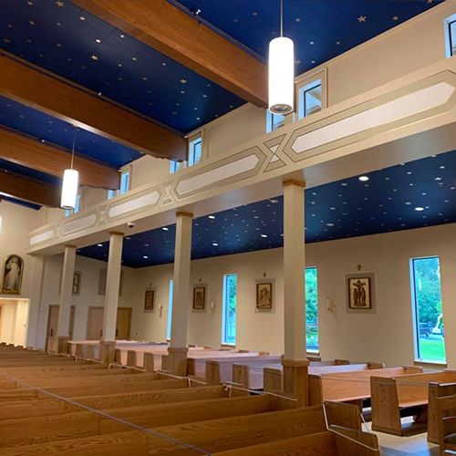 Pews, pendant lighting and clerestory windows in the completed church