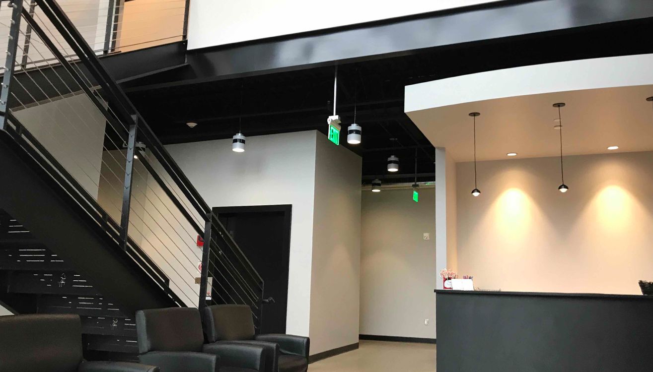 Reception area with an open stair and exposed structural steel.