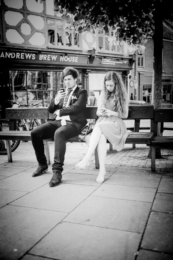Together, Separately two people on their phone ignoring each other